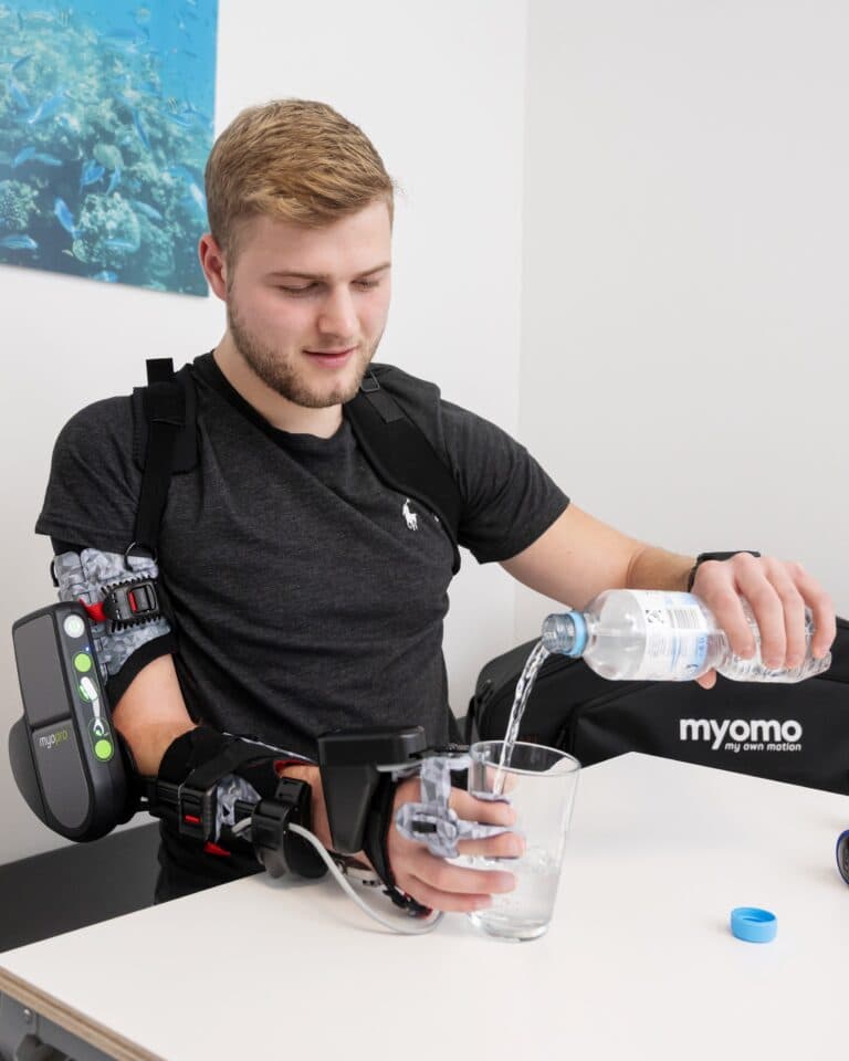 Patient using MyoPro myoelectric arm orthosis